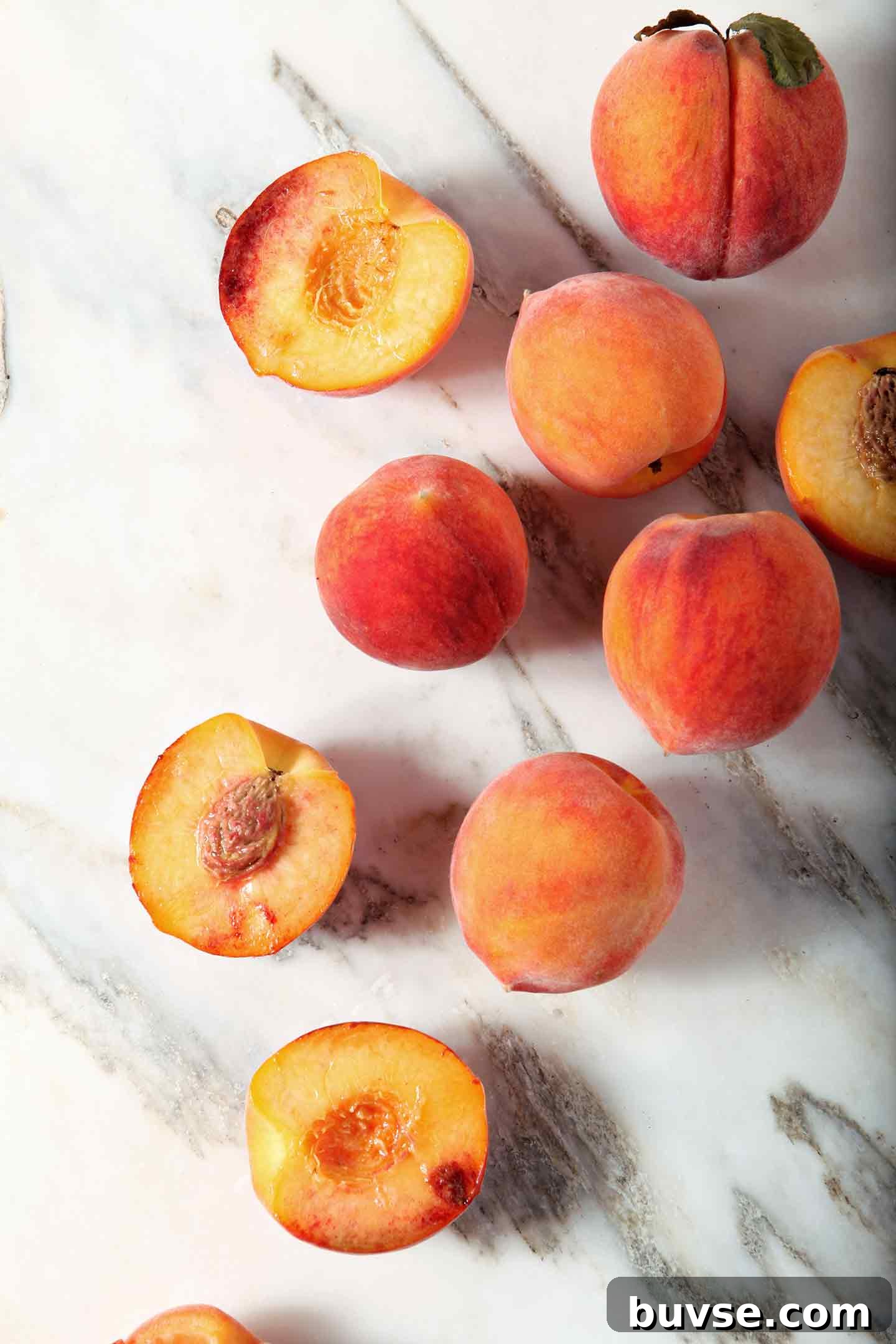 Summer Ricotta Crostini with Grilled Peaches 3 Some whole and some halved peaches on marble