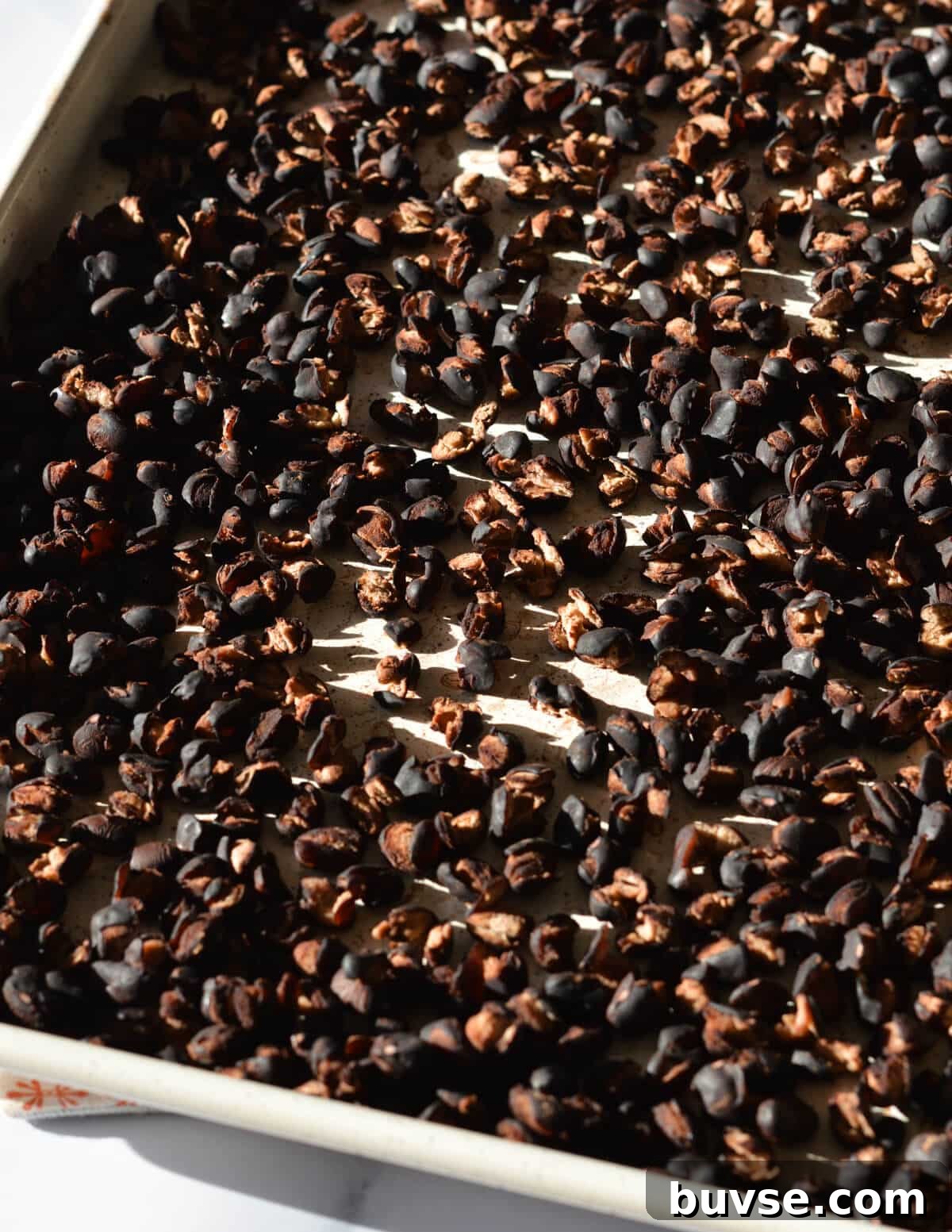 cooked black beans on a sheet pan.