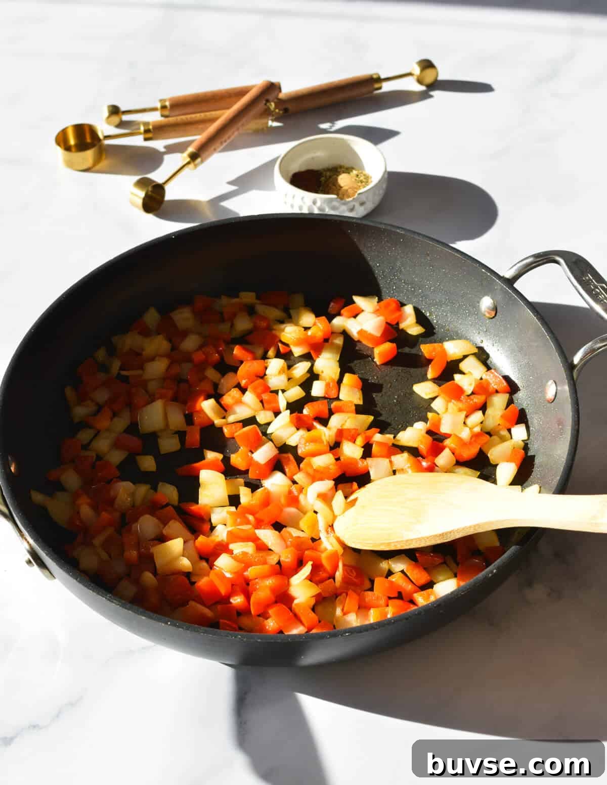 sauteing peppers and onions in a skillet.