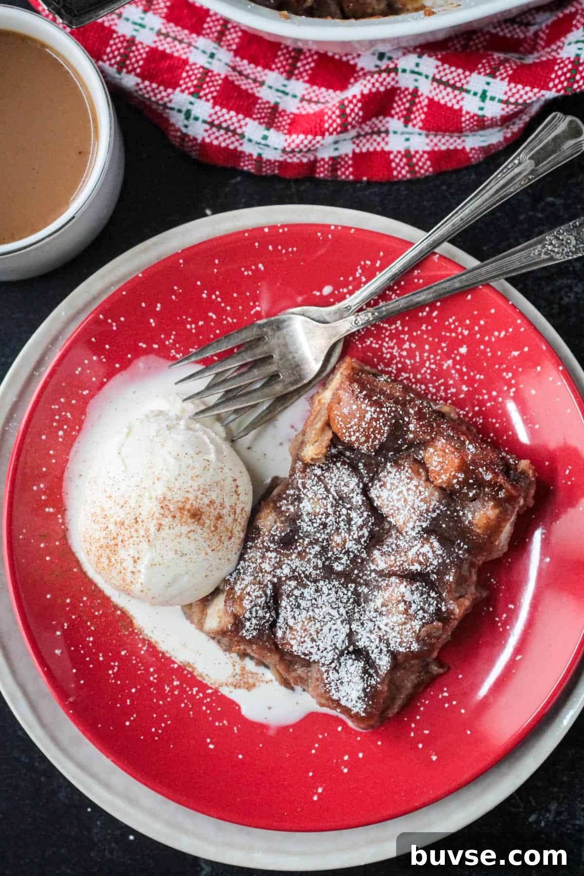 Creamy Vegan Bread Pudding Recipe with Cinnamon 2 Slice of vegan bread pudding on a red plate with a scoop of vanilla ice cream.