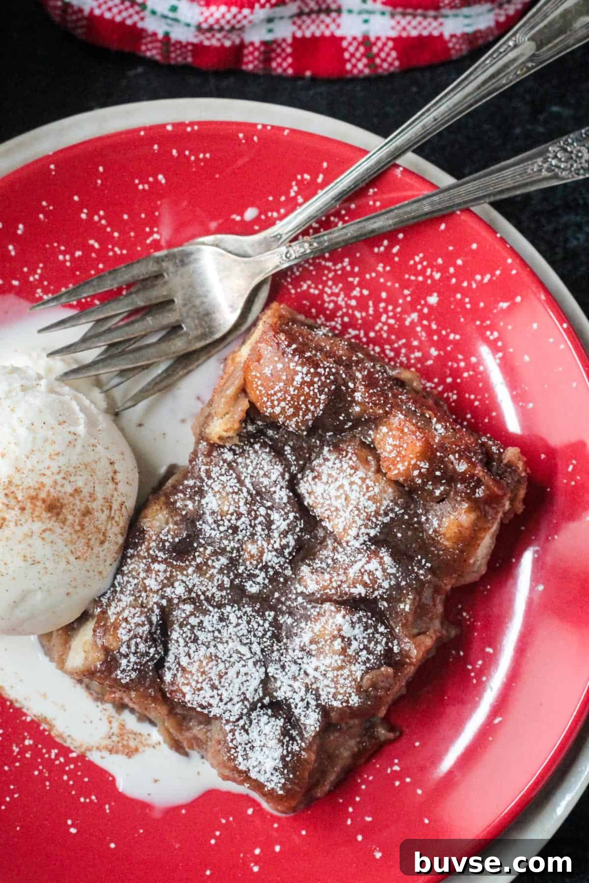 Creamy Vegan Bread Pudding Recipe with Cinnamon 15 Close up of powdered sugar topping on a slice of bread pudding.