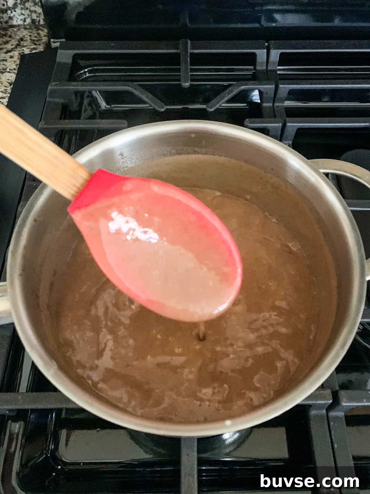 Creamy Vegan Bread Pudding Recipe with Cinnamon 8 Thick custard coating a spoon.