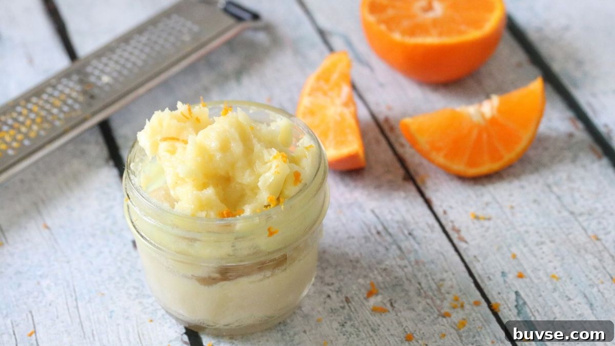 Mason jar with homemade body butter in it and orange zest on top.