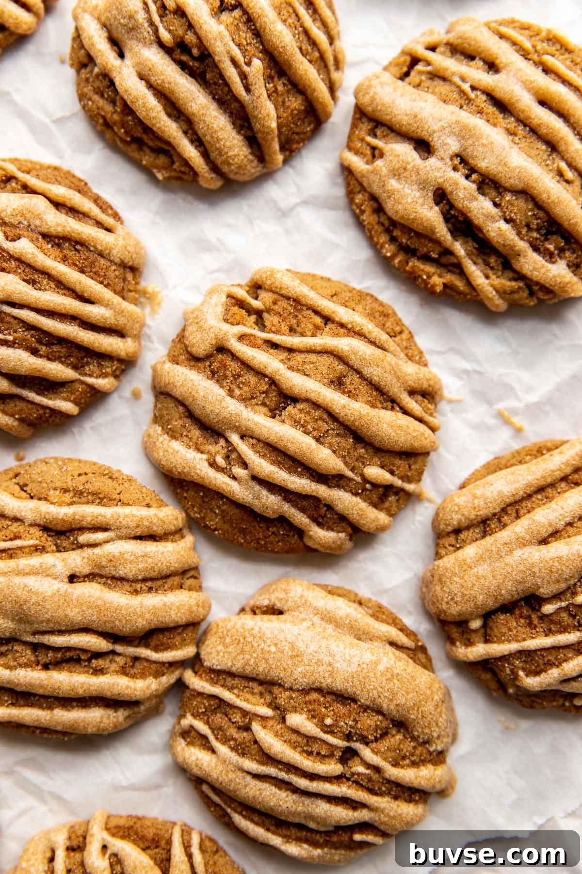 glazed apple butter cookies on white parchment paper.