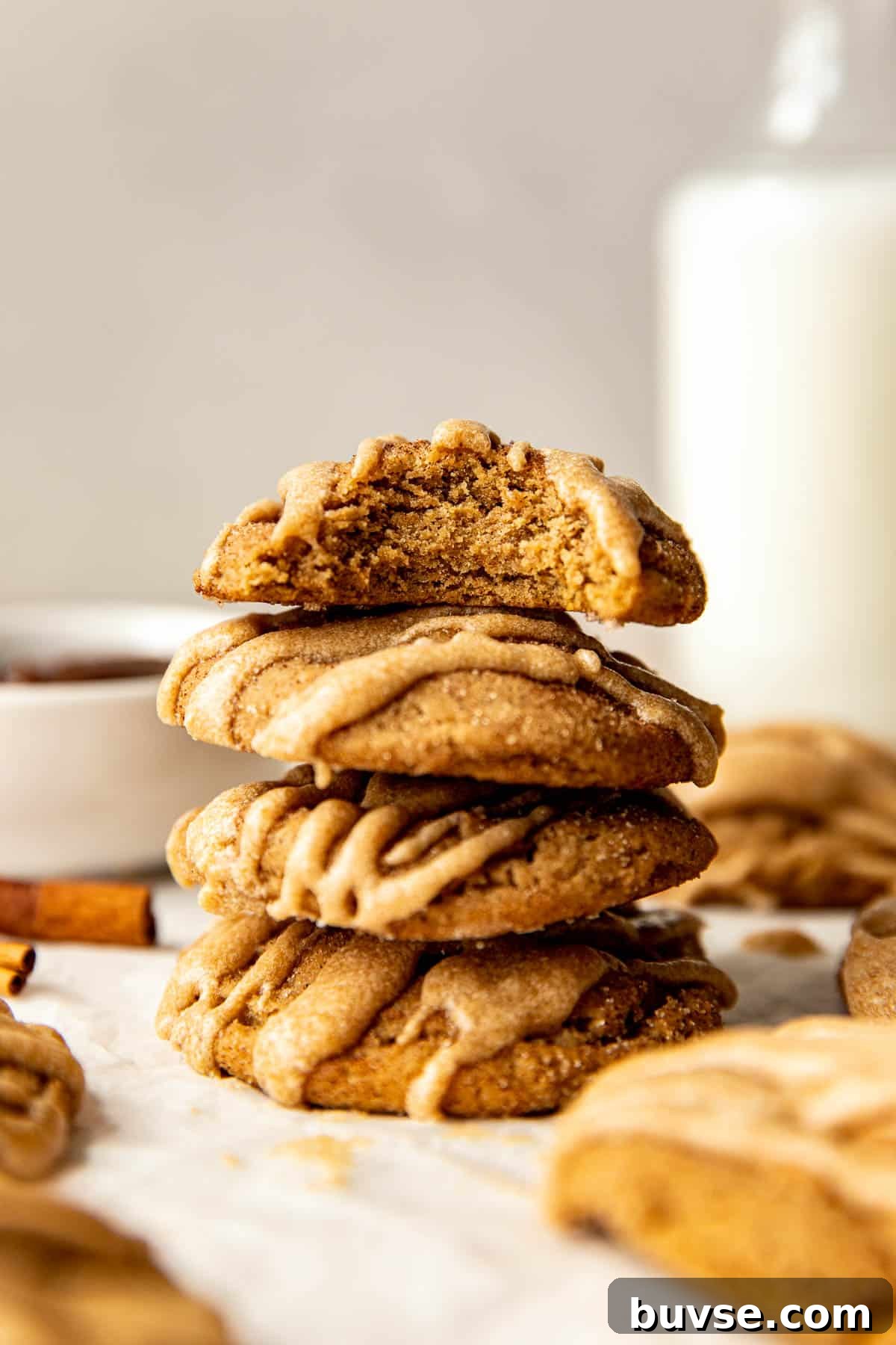 a stack of cookies with a bite taken out of the top cookie.
