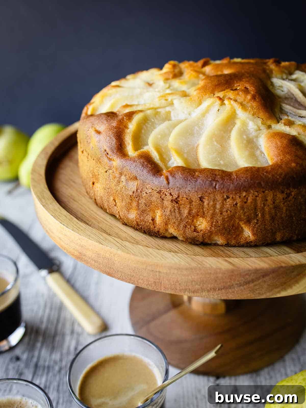 Italian Pear Cake on a wooden cake stand.