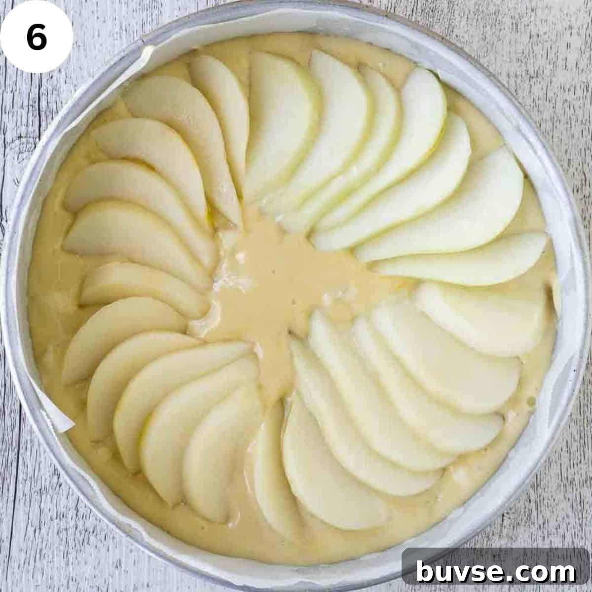 Pear slices in a concentric circle on top of cake batter.