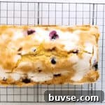 baked sugar-topped blueberry lemon pound cake on a wire rack.
