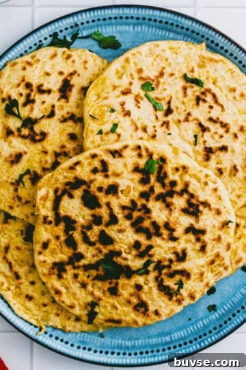 Overhead shot of homemade chickpea flatbread on a blue plate.