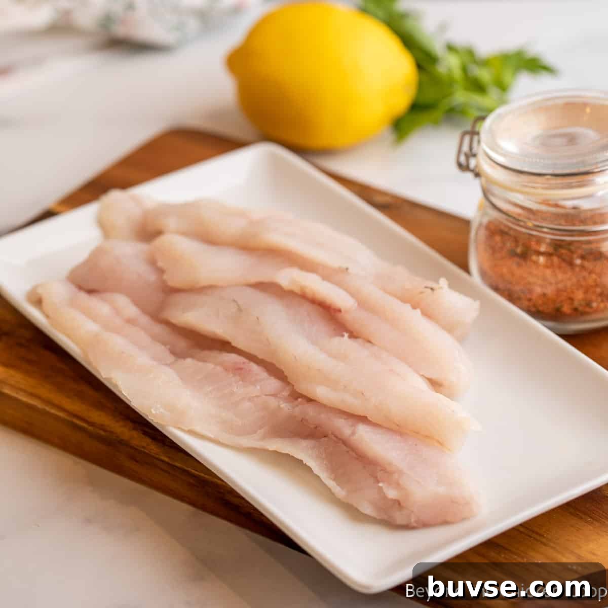 Fillets of walleye on a white platter.