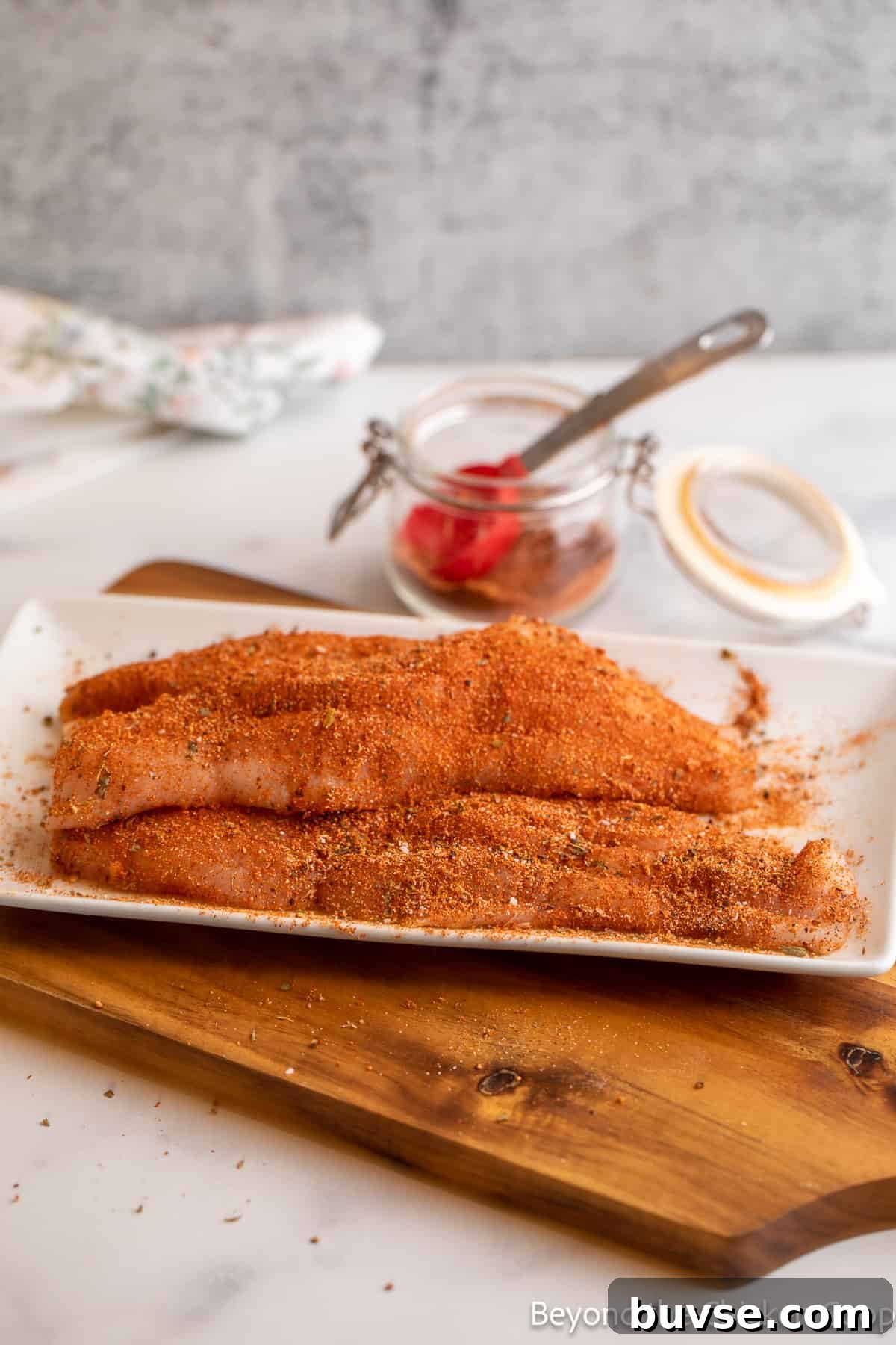 Fish fillets covered in seasoning.