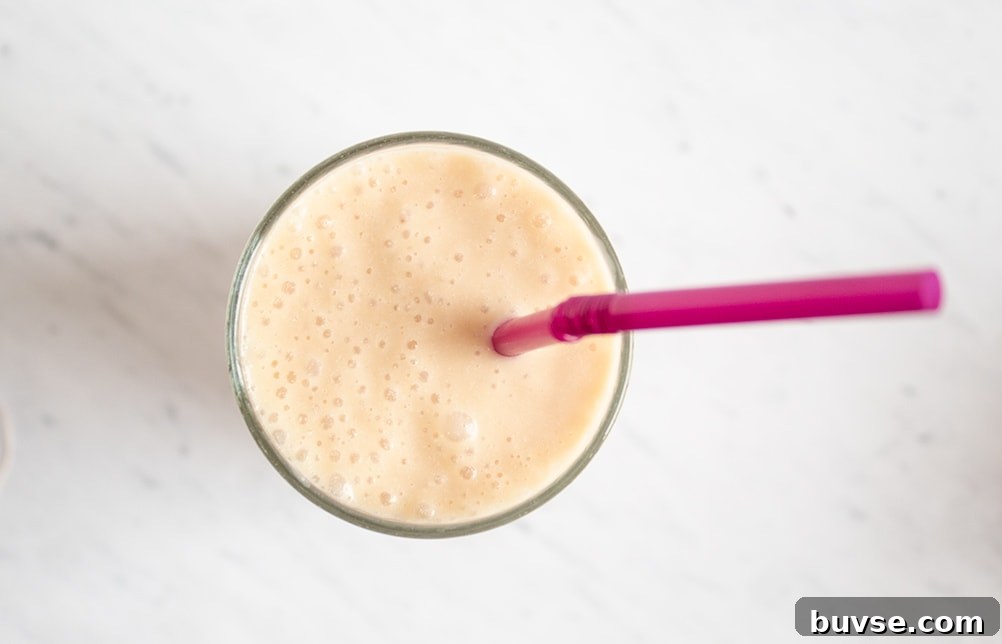 overhead view of keto smoothie with purple straw sticking out