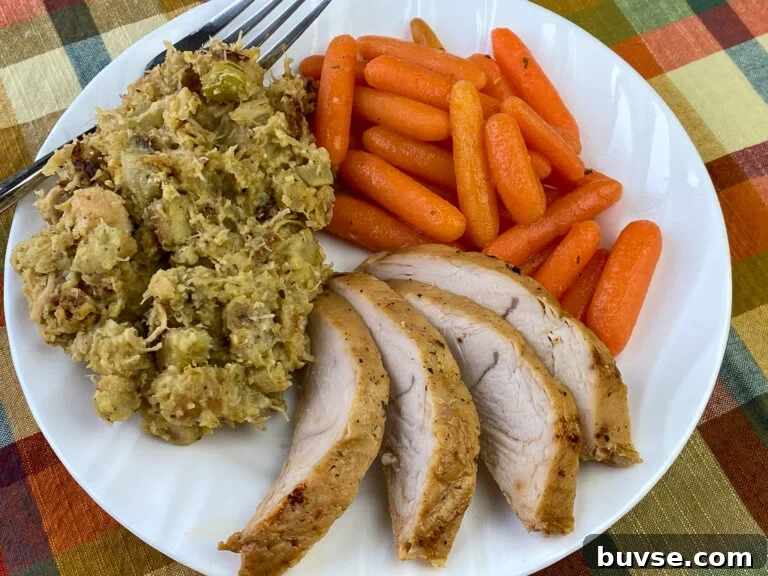 Moist dressing on a plate with turkey and carrots with a fork in the background