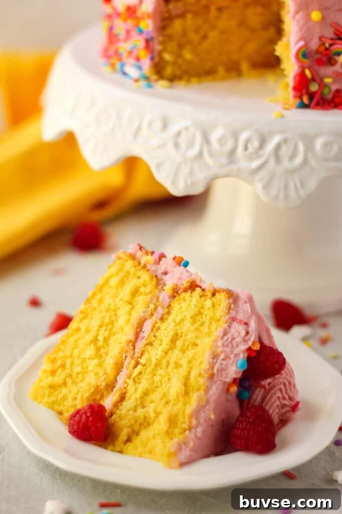 Lemon Raspberry Birthday Cake Recipe 6 close up of slice of lemon raspberry birthday cake on white plate