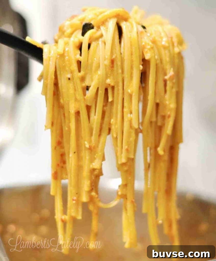 holding pasta in a spoon.