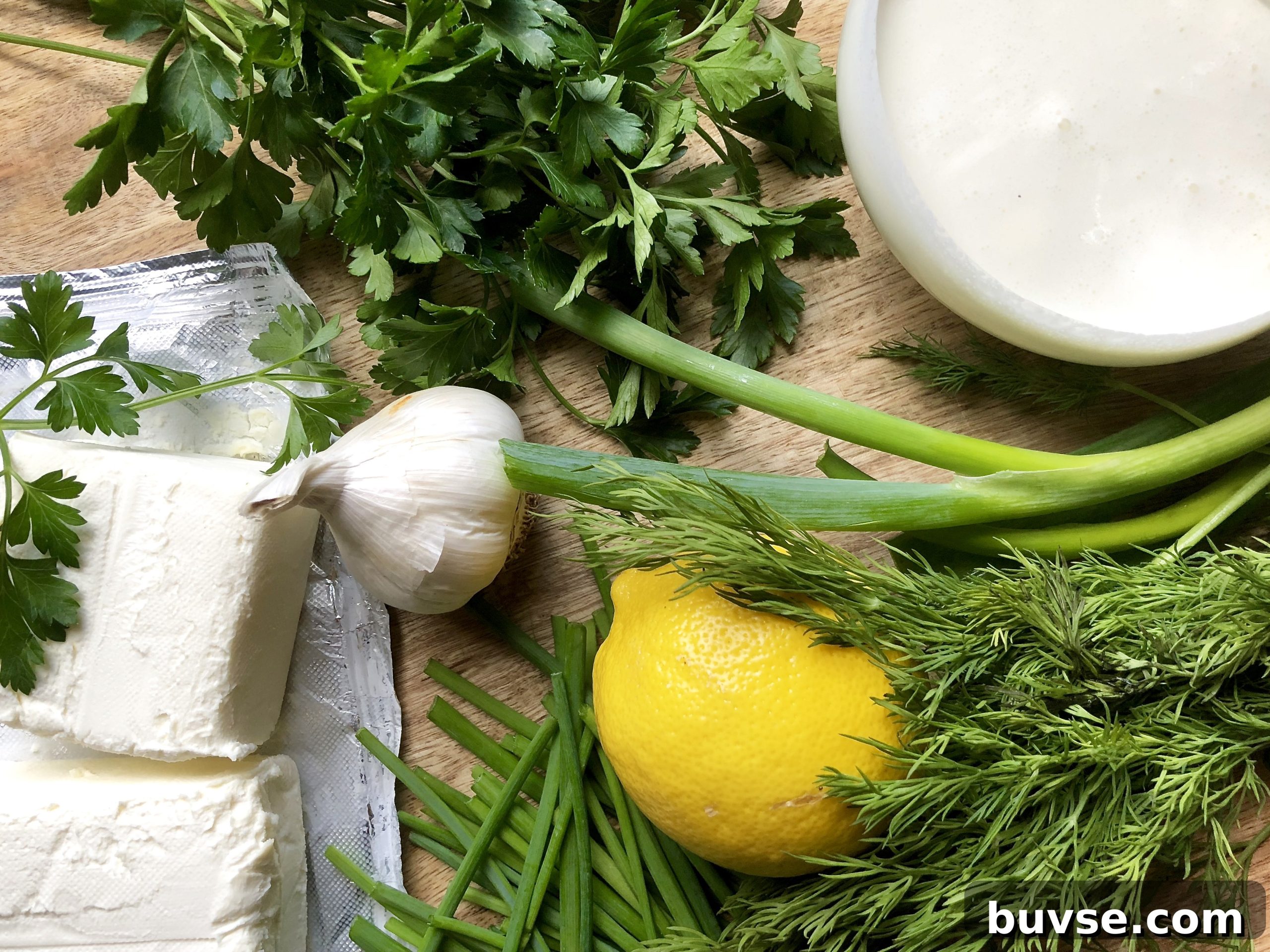 Creamy herbed dip with lemon and dill on a plate