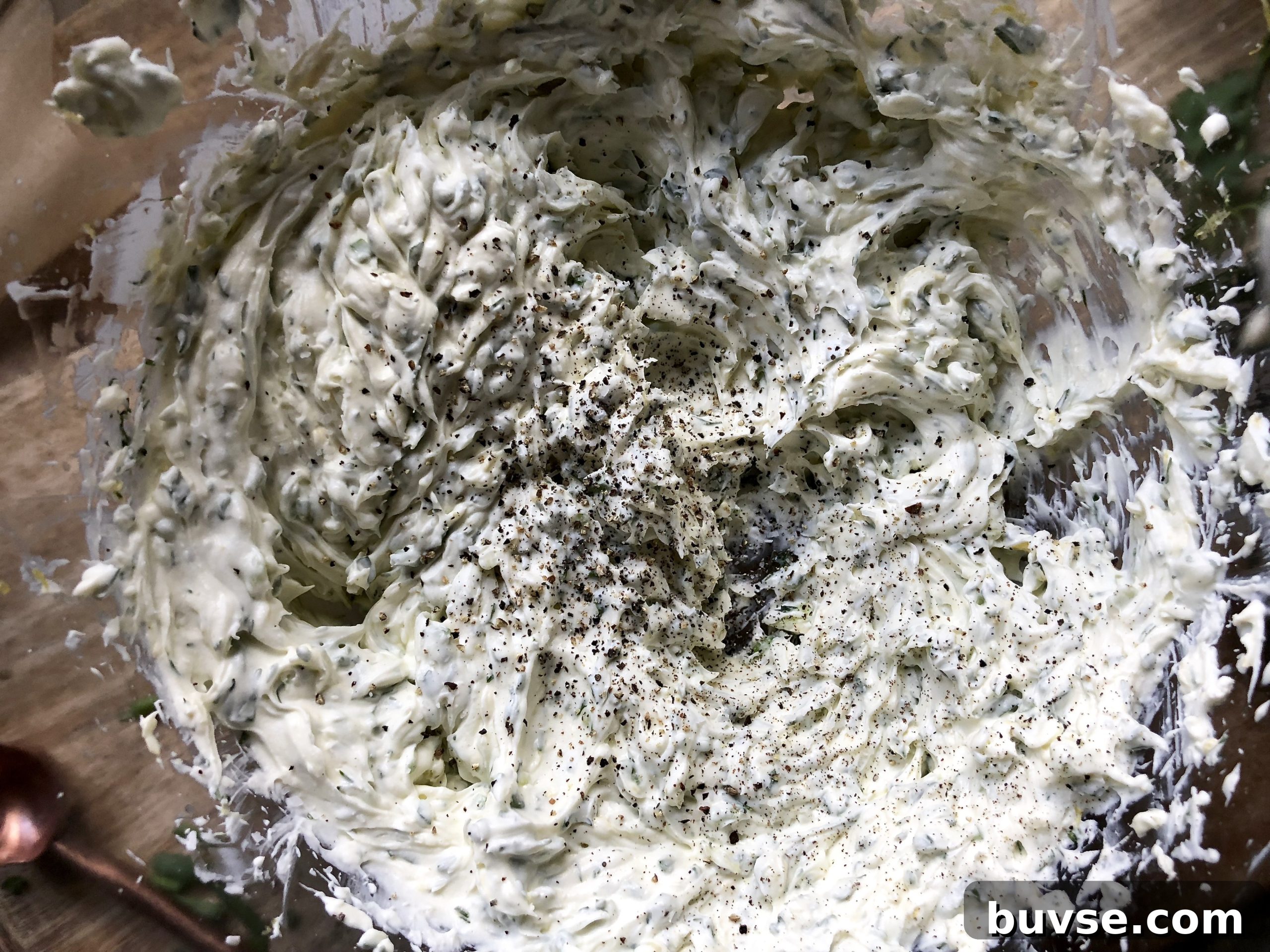 Bowl of creamy herbed dip garnished with herbs