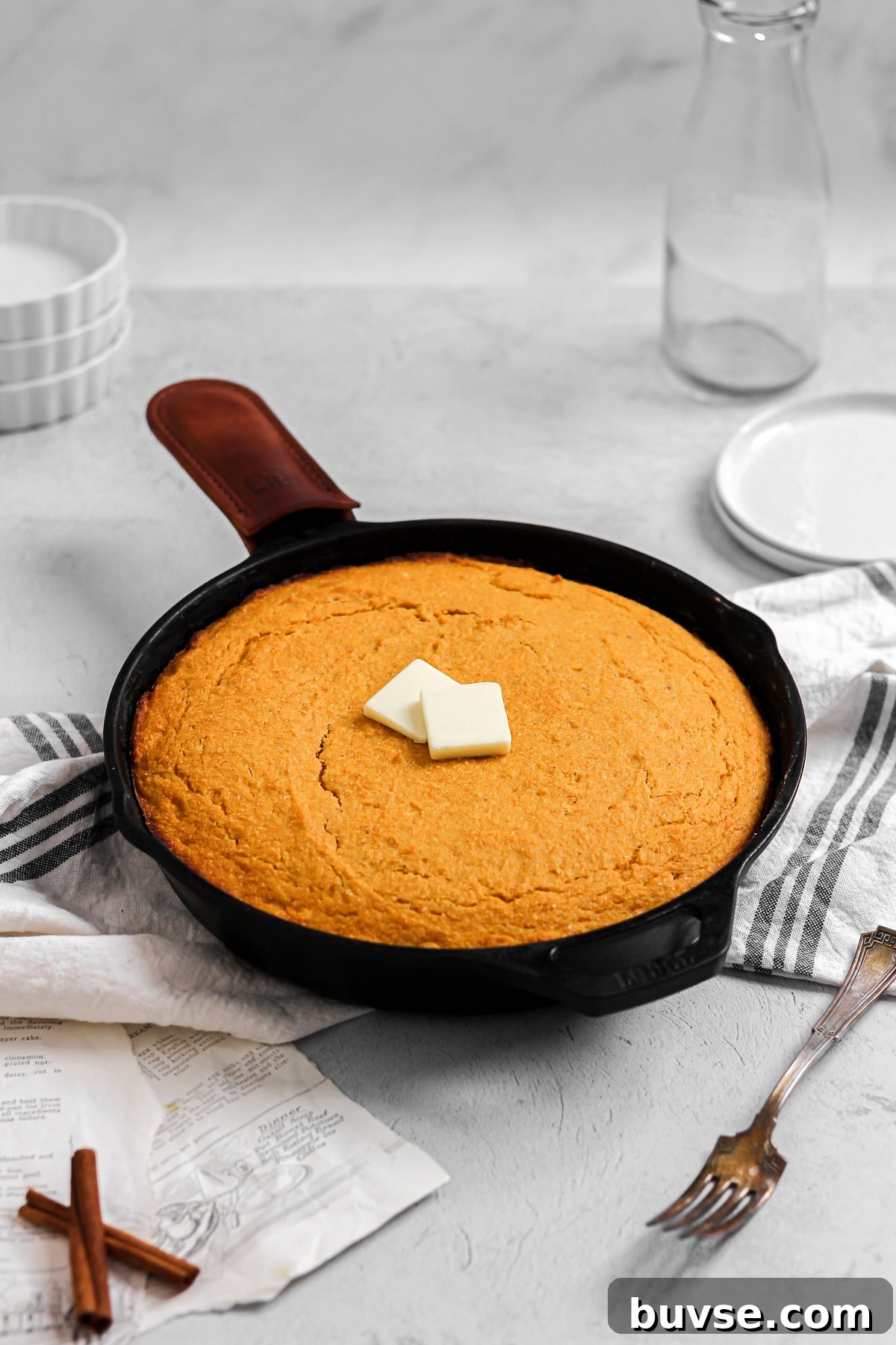 sweet potato cornbread with butter in a cast iron skillet
