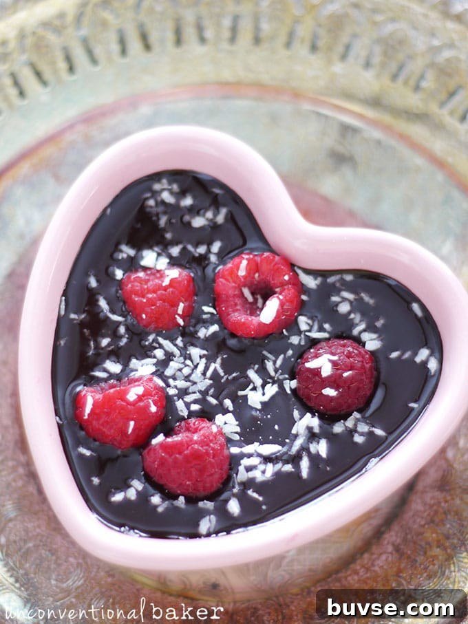 Chocolate-coated raspberries topped with coconut