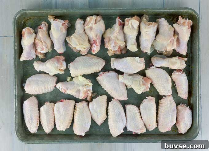raw chicken wings on a baking sheet