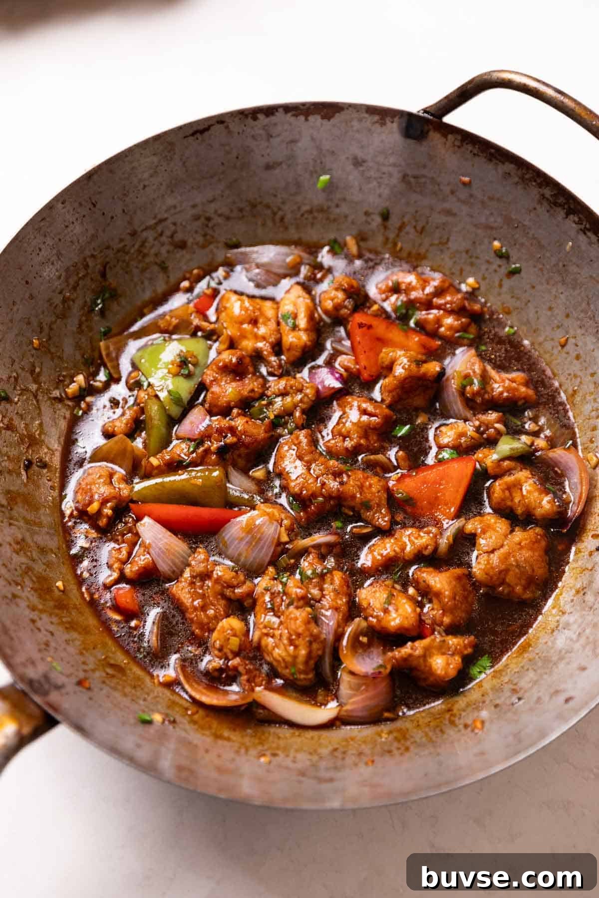 Authentic Street Style Chicken Manchurian 3 freshly cooked chicken manchurian in a wok, ready to be served