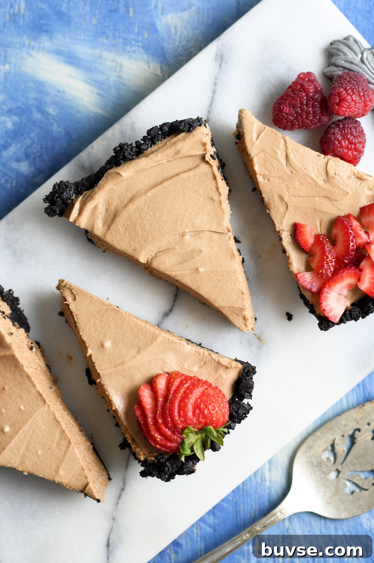 Finished no bake Nutella and Oreo cheesecake garnished with strawberry slices