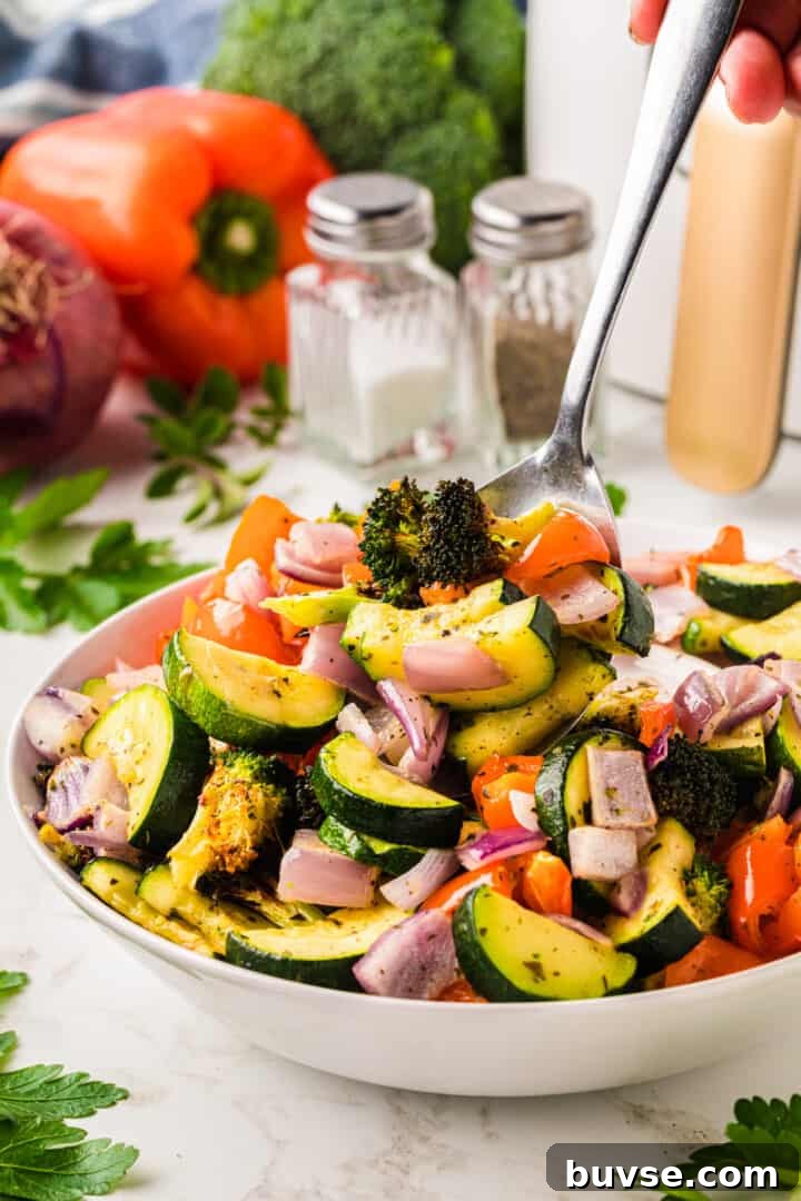 Crispy Air Fryer Vegetables: Quick Roasting Tips 12 serving the air fryer vegetables from the white bowl.