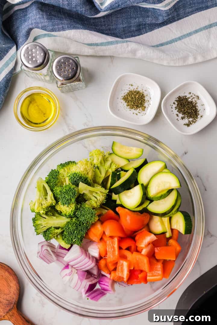 Crispy Air Fryer Vegetables: Quick Roasting Tips 6 diced vegetables in glass bowl for oil and seasoning.