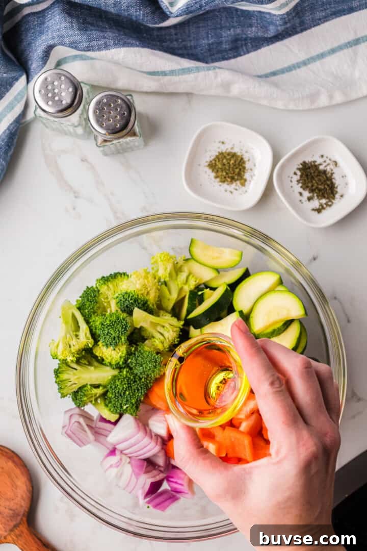Crispy Air Fryer Vegetables: Quick Roasting Tips 7 adding oil to the veggies.