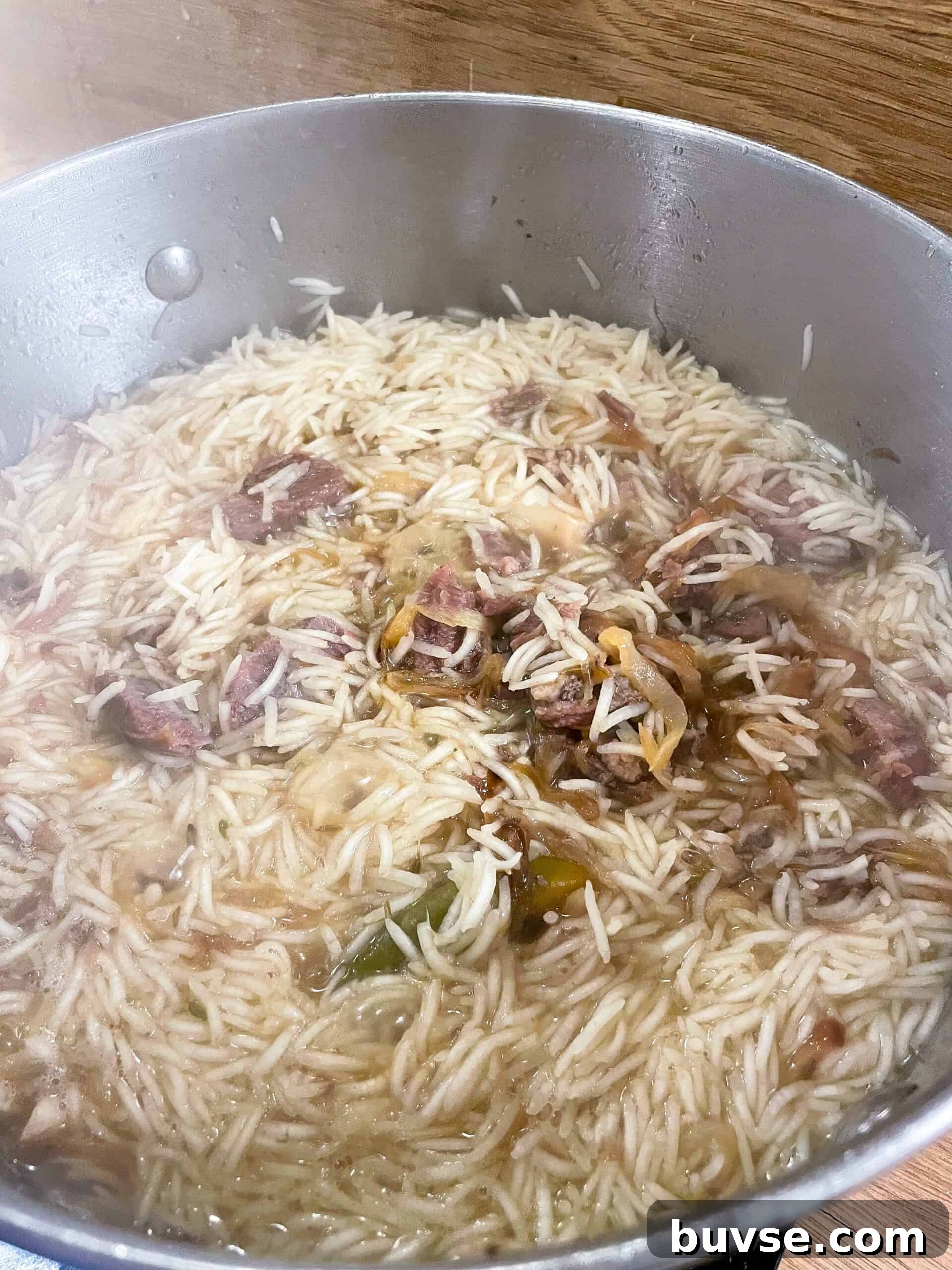 Mutton Yakhni Pulao Recipe: Aromatic Eid Rice Dish 8 Partially cooked rice