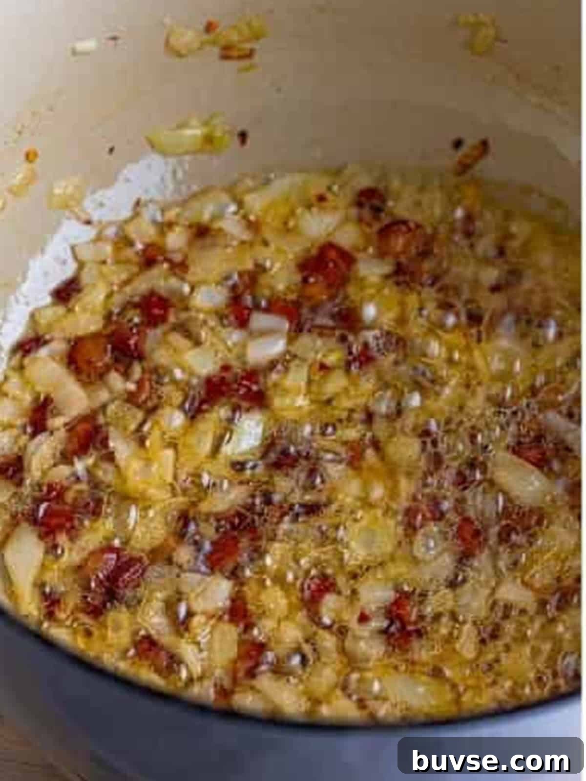 Amatriciana Pasta (Bucatini) - Authentic Italian Recipe 4 Diced guanciale crisping in olive oil in a Dutch oven for Pasta Amatriciana.