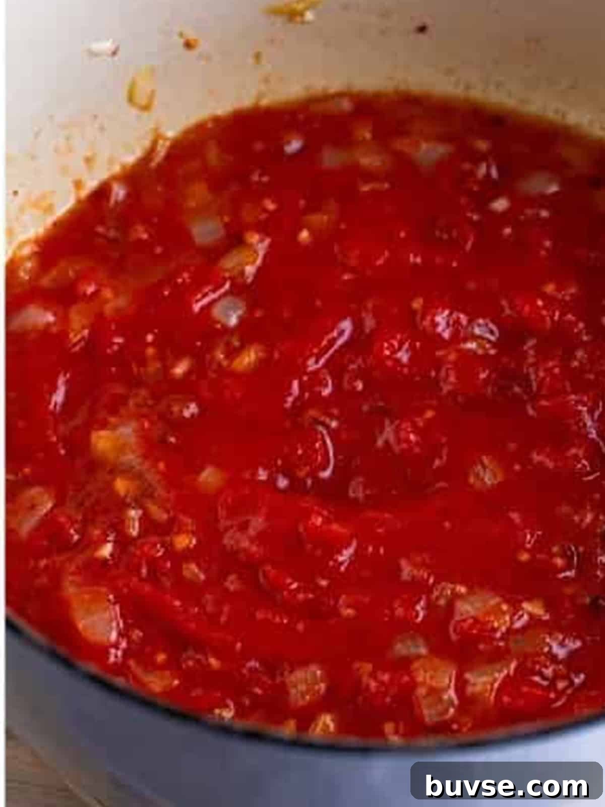 Amatriciana Pasta (Bucatini) - Authentic Italian Recipe 6 Hand crushed San Marzano tomatoes simmering into a thick sauce for Pasta Amatriciana.