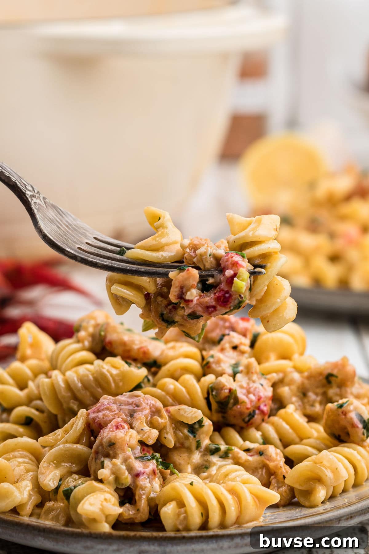 close up of crawfish monica on a plate with a fork digging in