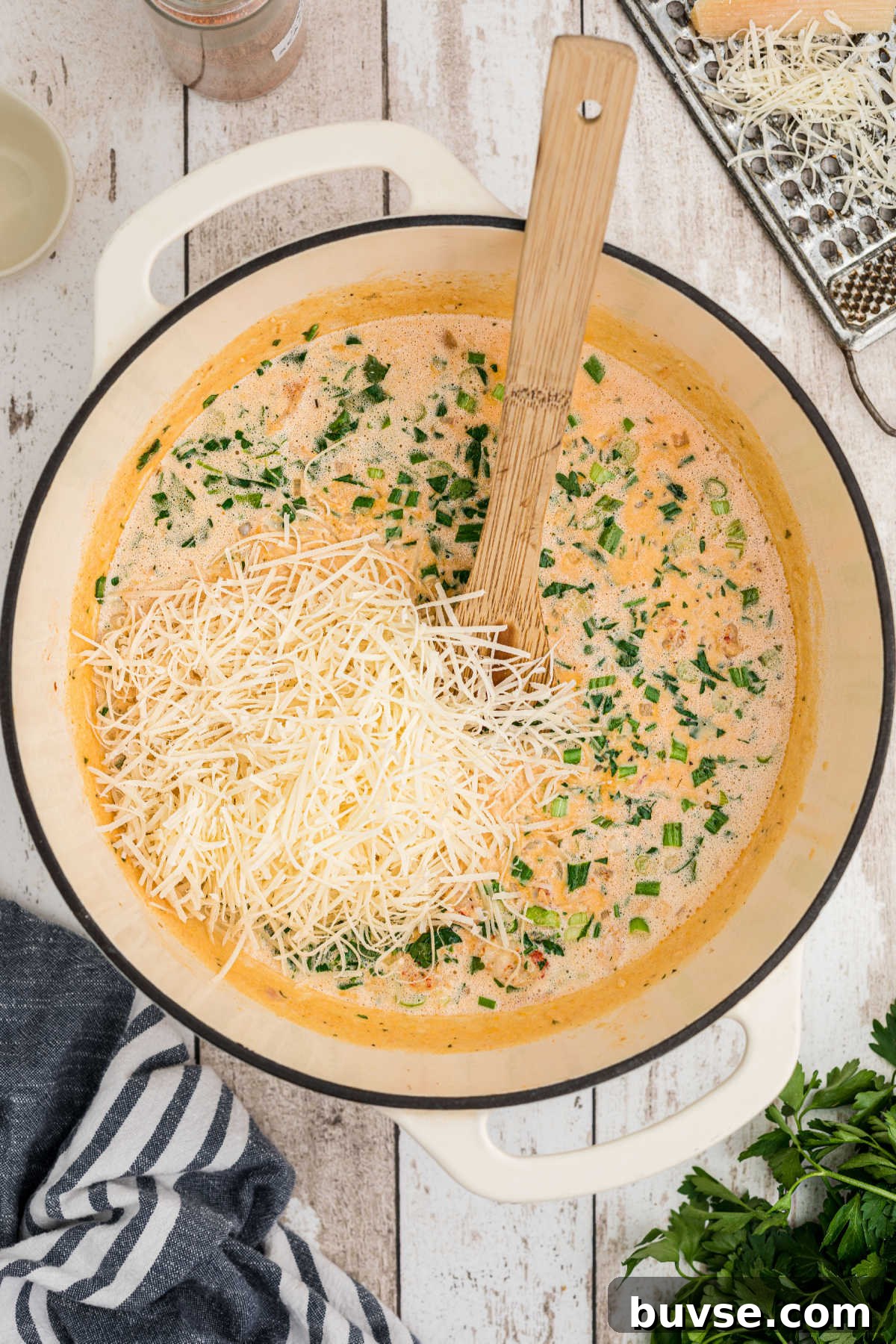 Freshly grated parmesan added to a sauce.