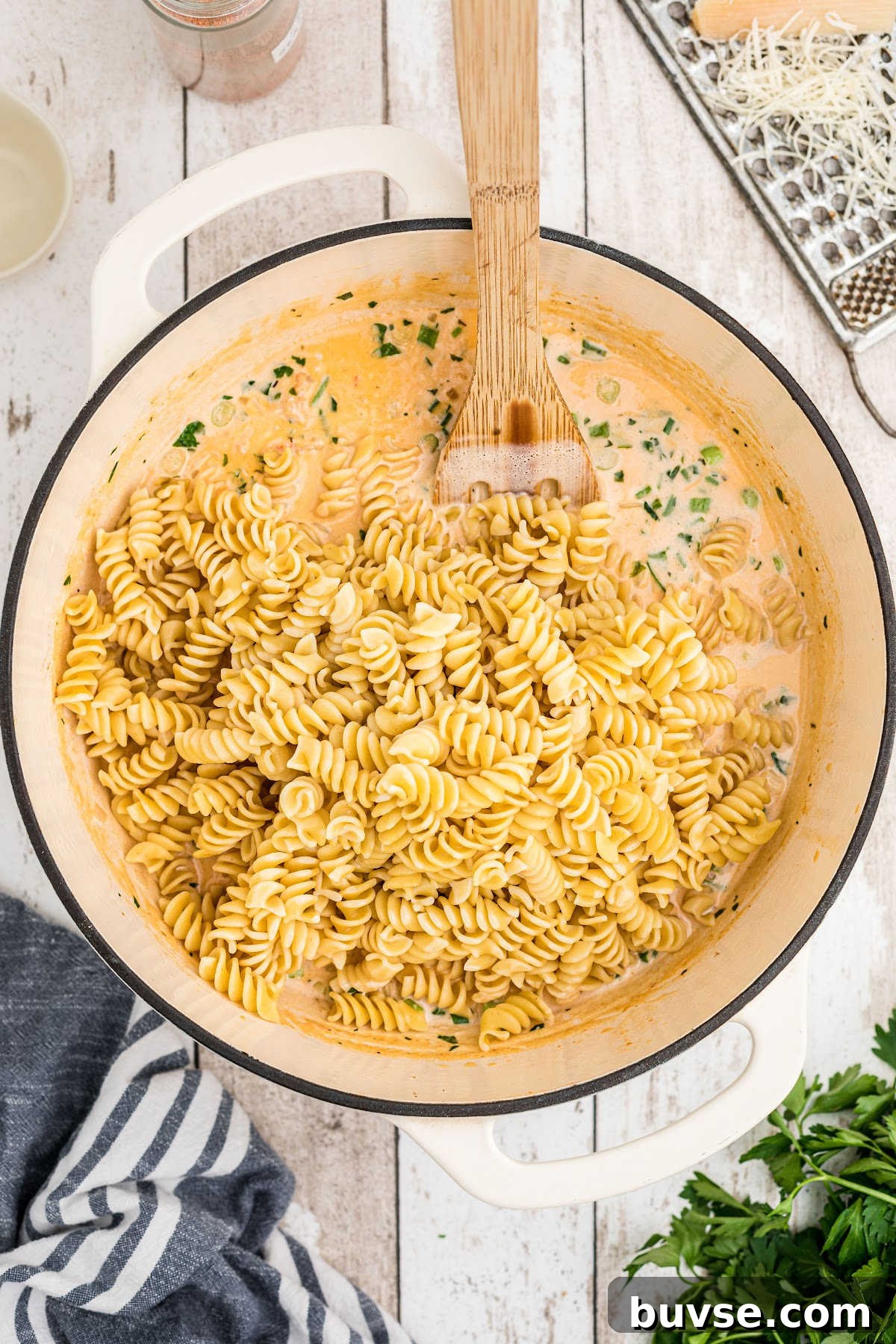 Cooked noodles added to creamy crawfish sauce.