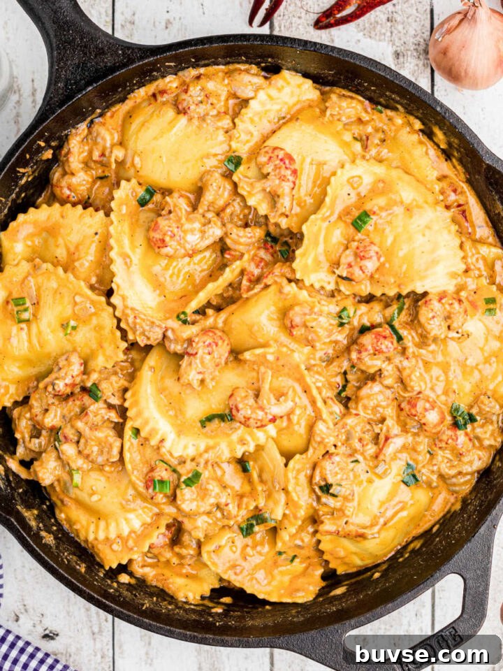 close up of a skillet of crawfish ravioli with boiled crawfish on the outside peeking in