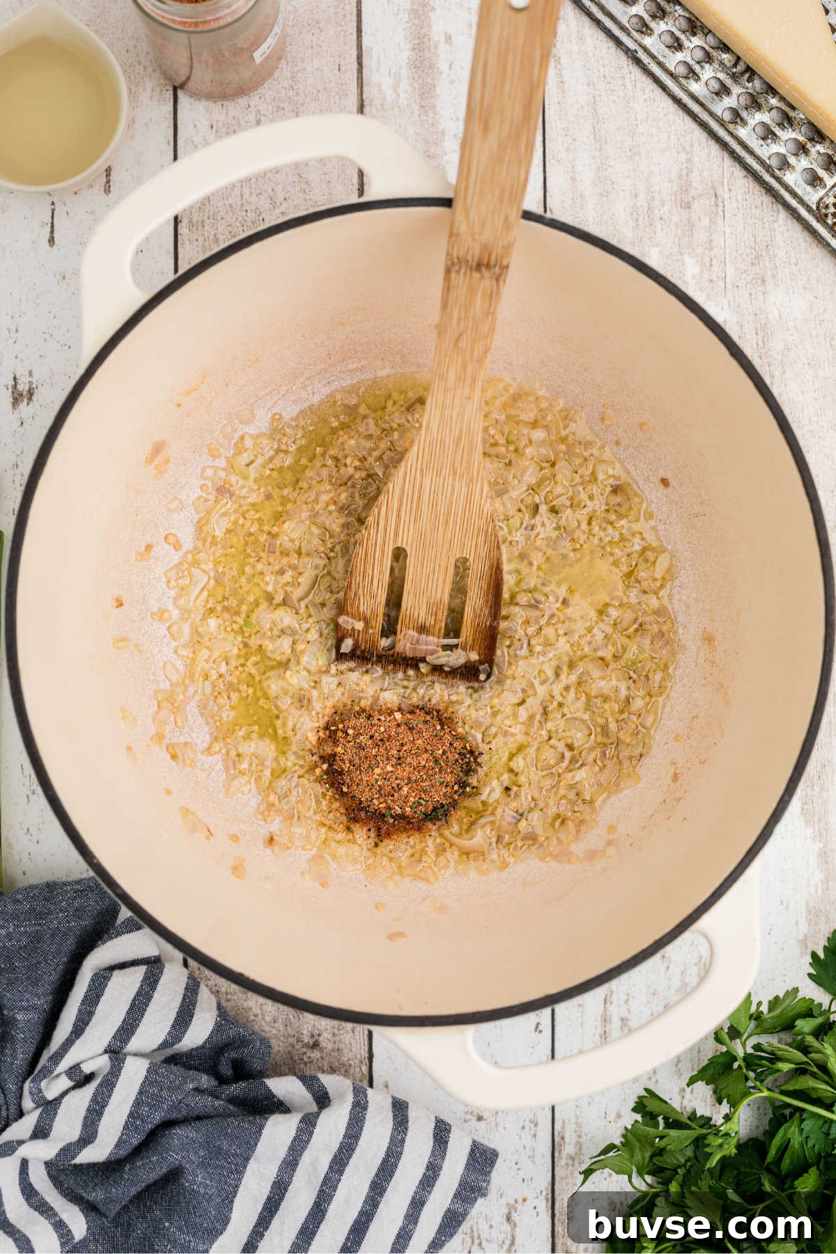 Seasonings added to a pot with shallots and garlic.