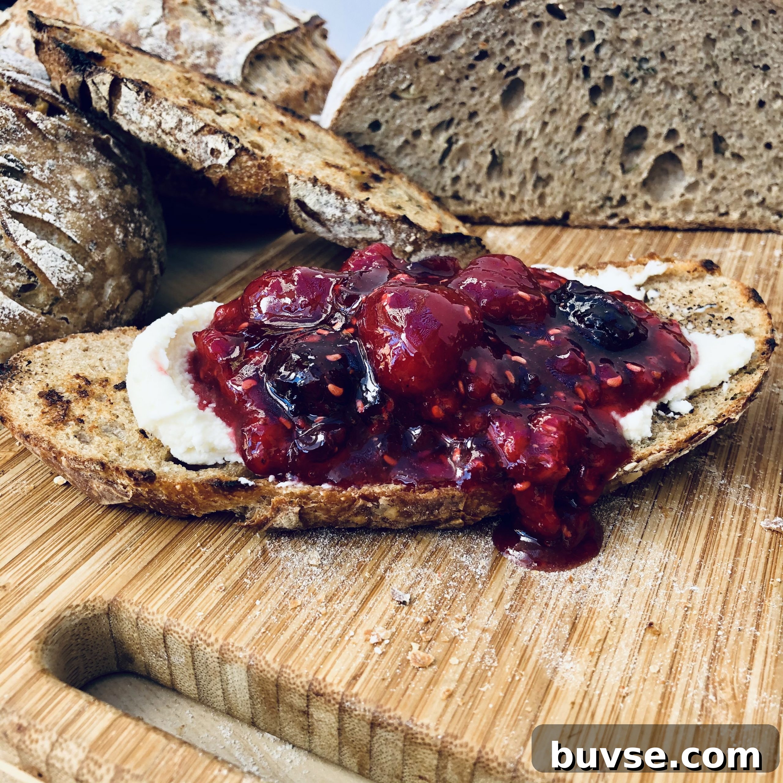 Mascapone cheese with berry preserves on roasted garlic and herbs sourdough