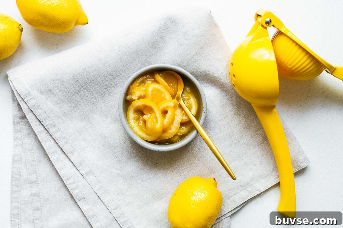 Preserved Lemon Substitute: What to Use Instead 3 A small ceramic bowl with slices of cheat's preserved lemon with a gold tablespoon surrounded by whole lemons.