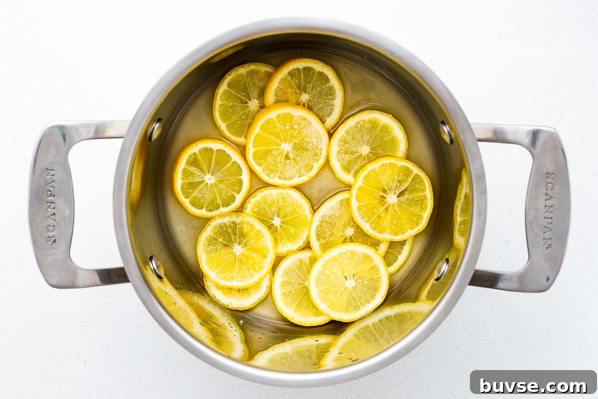 Preserved Lemon Substitute: What to Use Instead 5 Sliced lemons with lemon juice and salt in a stainless steel pot viewed from above.