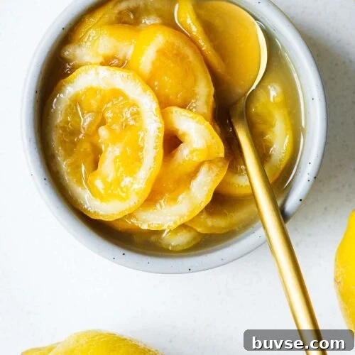 Top down close-up of a ceramic bowl with preserved lemon substitute and a gold spoon.