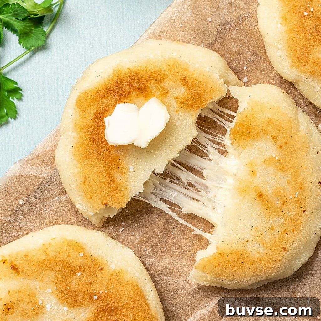 Cook Once, Eat Twice: Budget Recipes for Delicious Leftovers 10 top view of an arepa cut in half with melted cheese inside