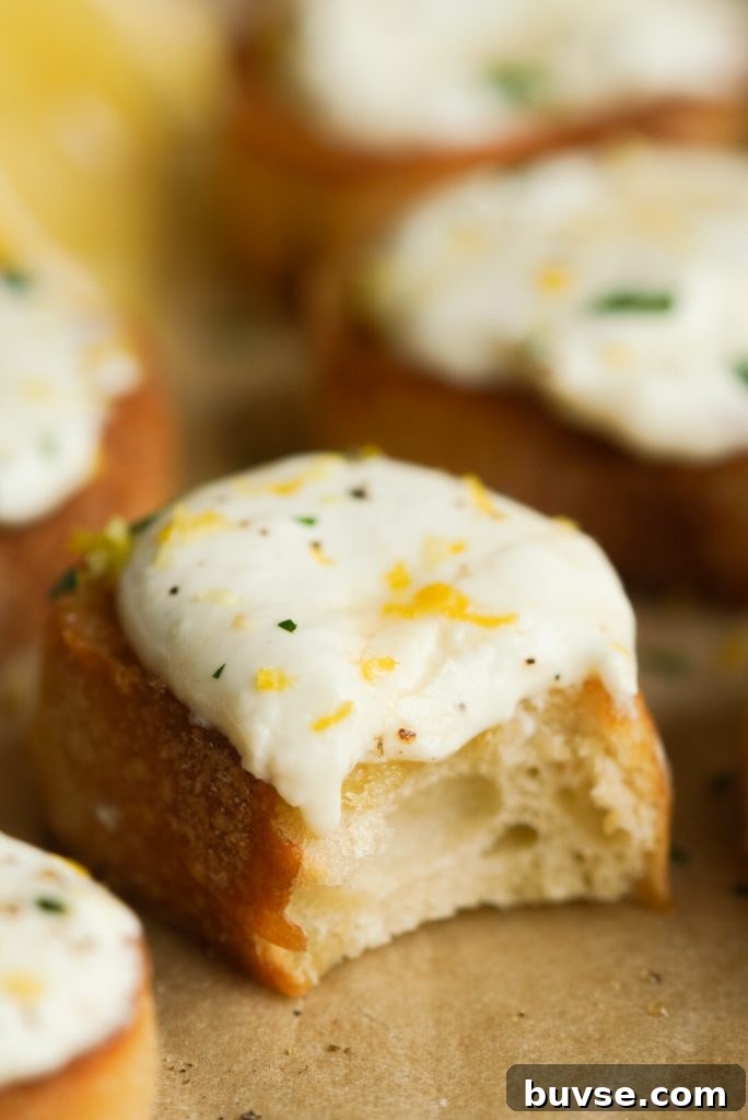 Whipped Ricotta Crostini with Honey and Lemon Zest 9 honey lemon whipped ricotta crostini with a bite taken out
