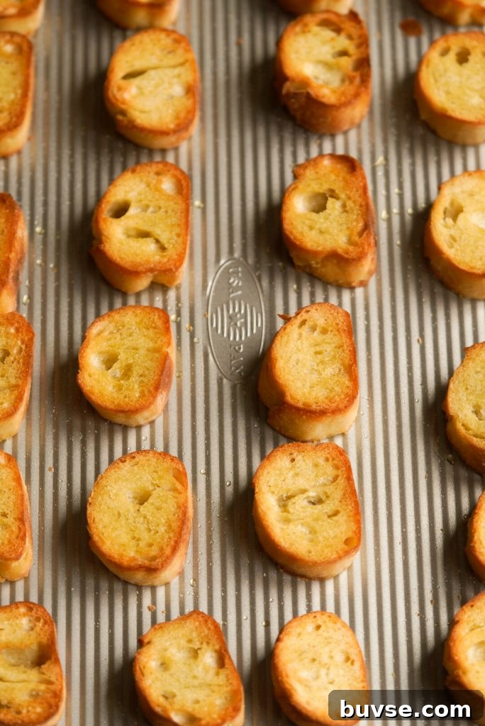 Whipped Ricotta Crostini with Honey and Lemon Zest 4 toasted french baguette slices on a baking tray