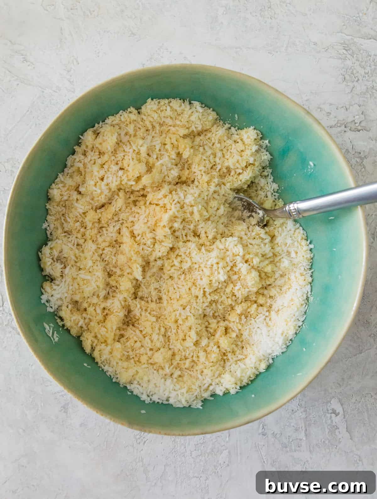 A bowl with almond flour and finely shredded coconut in it.