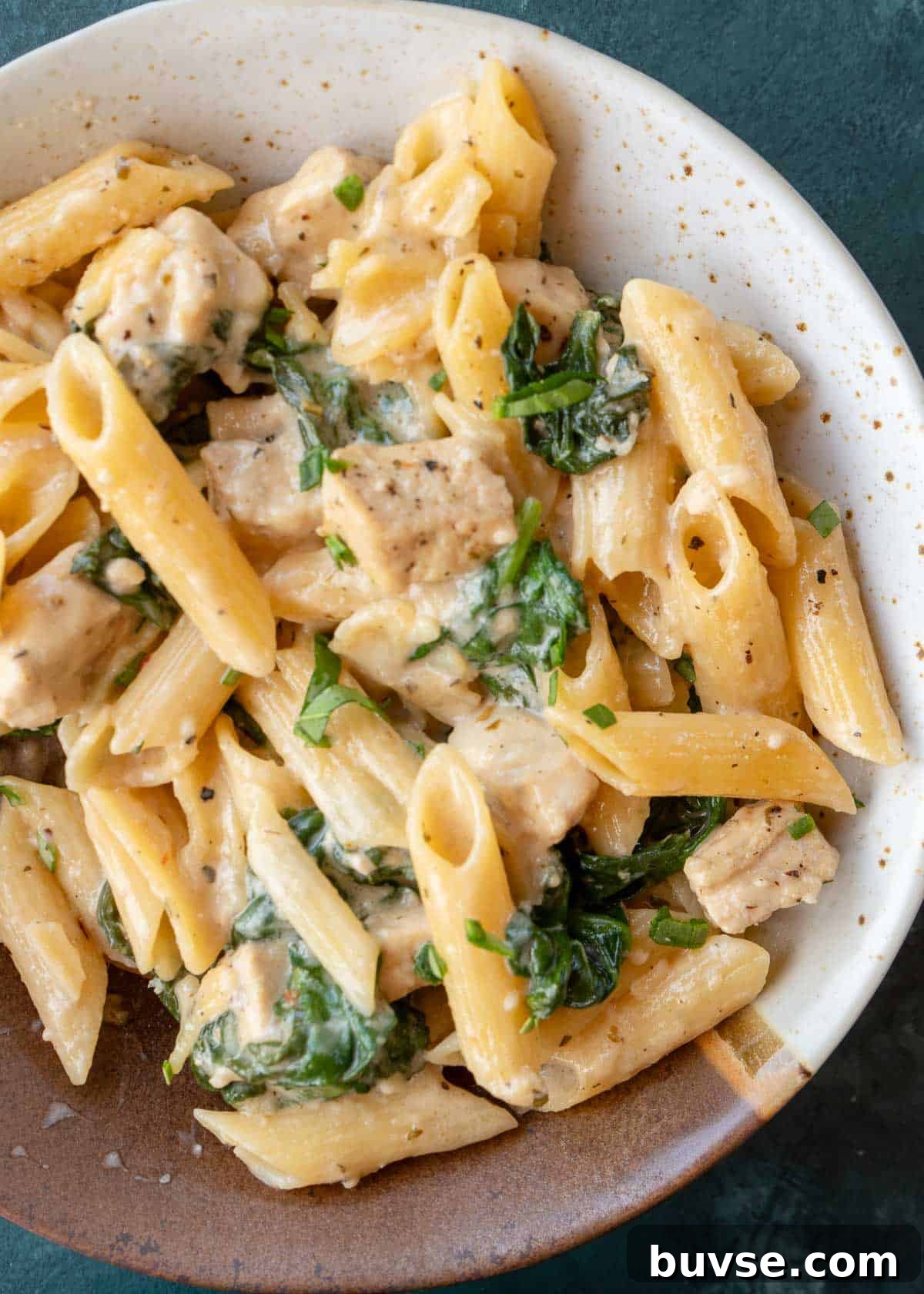 overhead shot of penne with chicken and spinach
