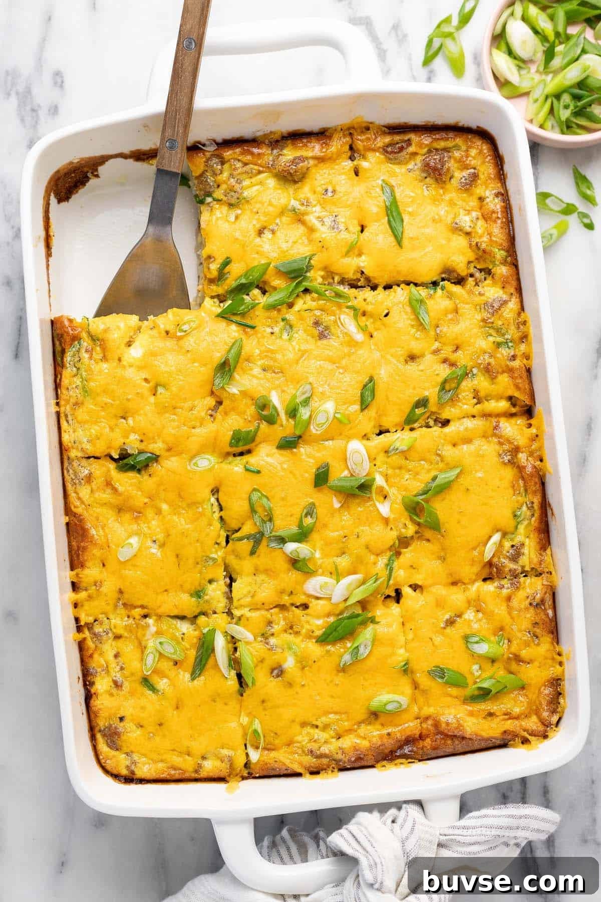 Cheesy Sausage Breakfast Casserole with Hash Browns 2 Large baking dish filled with homemade breakfast casserole recipe topped with green onion.