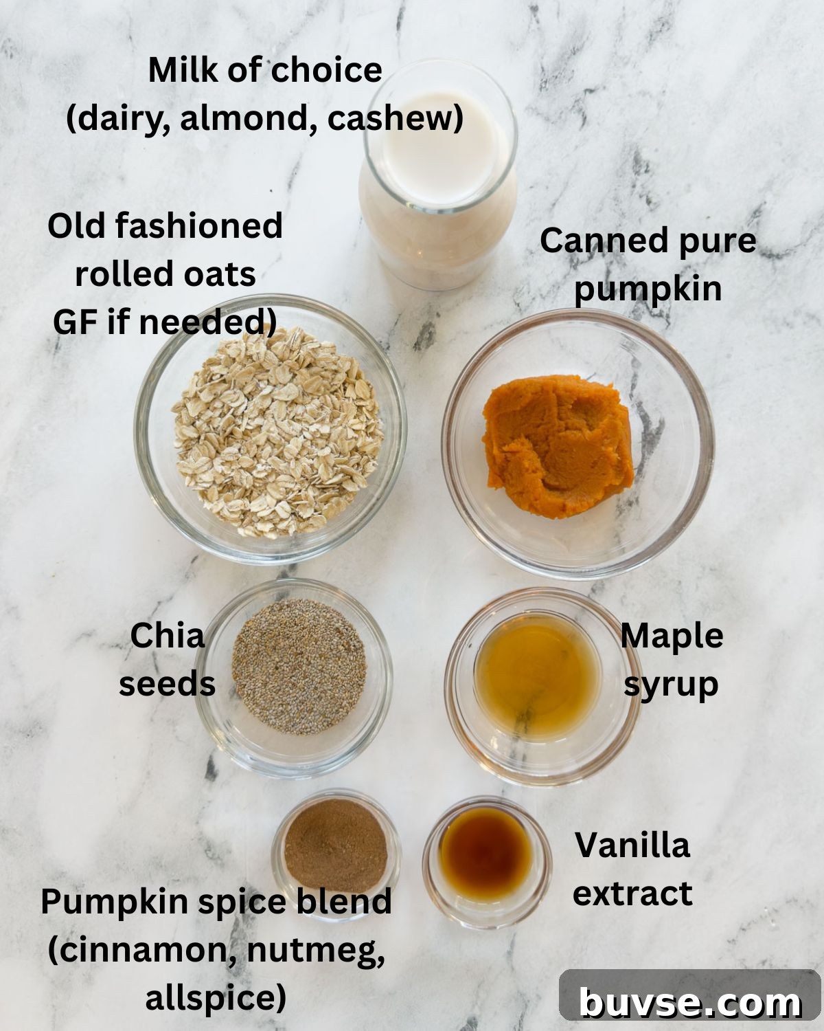 Ingredients for pumpkin overnight oats on a marble counter.