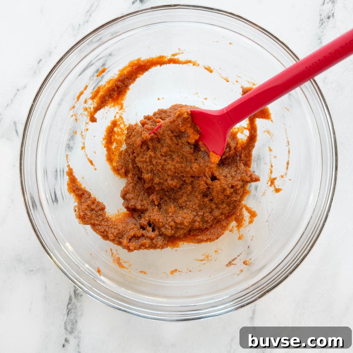 Mixing pumpkin, spices, and maple into a paste for overnight oats base.