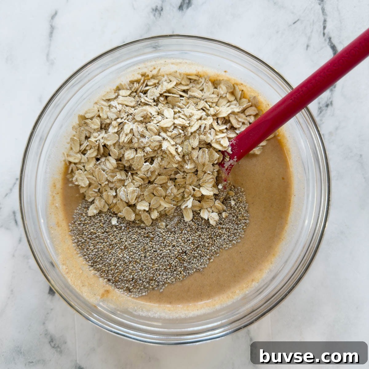 Overnight pumpkin oats base with chia seeds in a glass bowl.